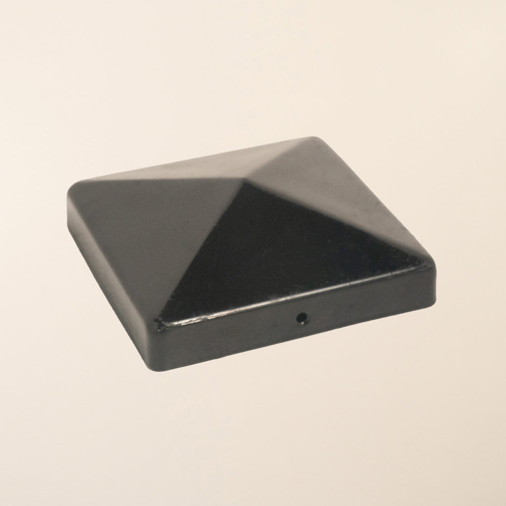 Black pyramid-shaped metal post cap with epoxy coating, designed to fit 100mm (4-inch) square fence posts 