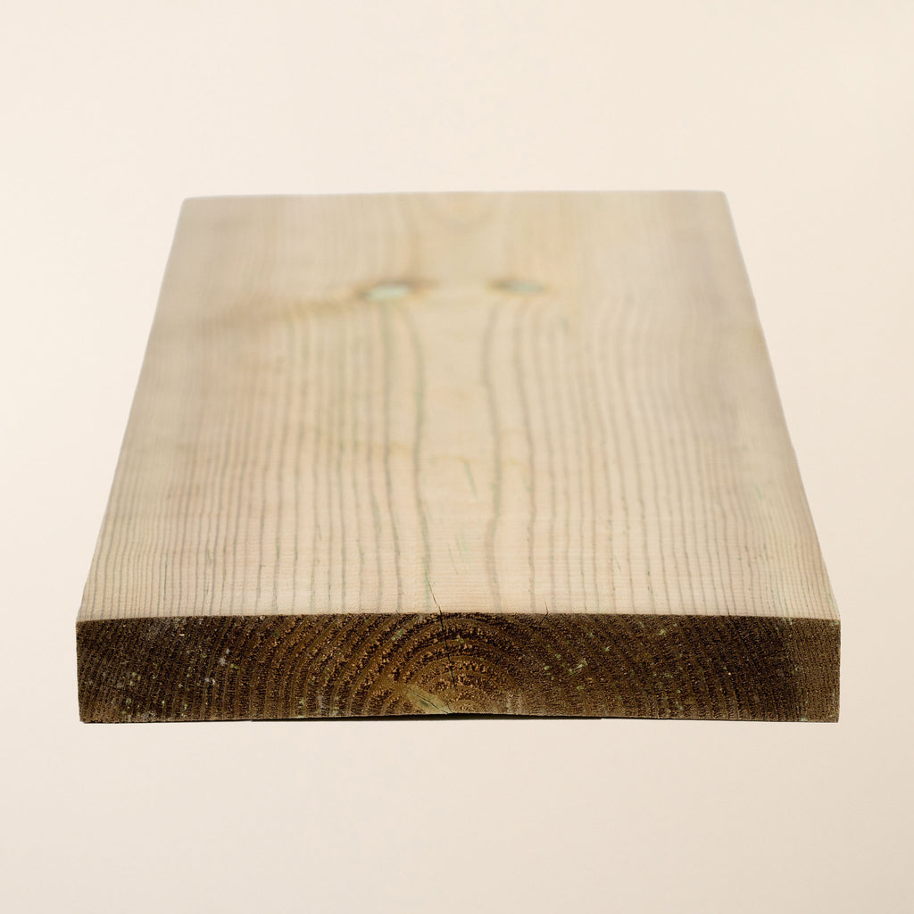 6-inch x 1-inch (145mm x 19mm) Treated Planed Square Edge timber board showing the smooth planed surface and green tanalith pressure treatment for outdoor durability 