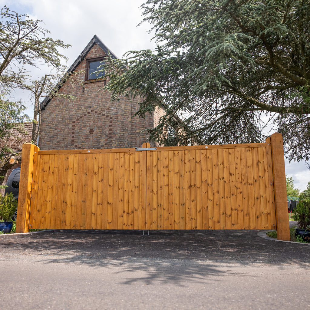Highampton tongue and groove entrance gates installed in residential driveway, showcasing traditional timber craftsmanship and elegant arched design 