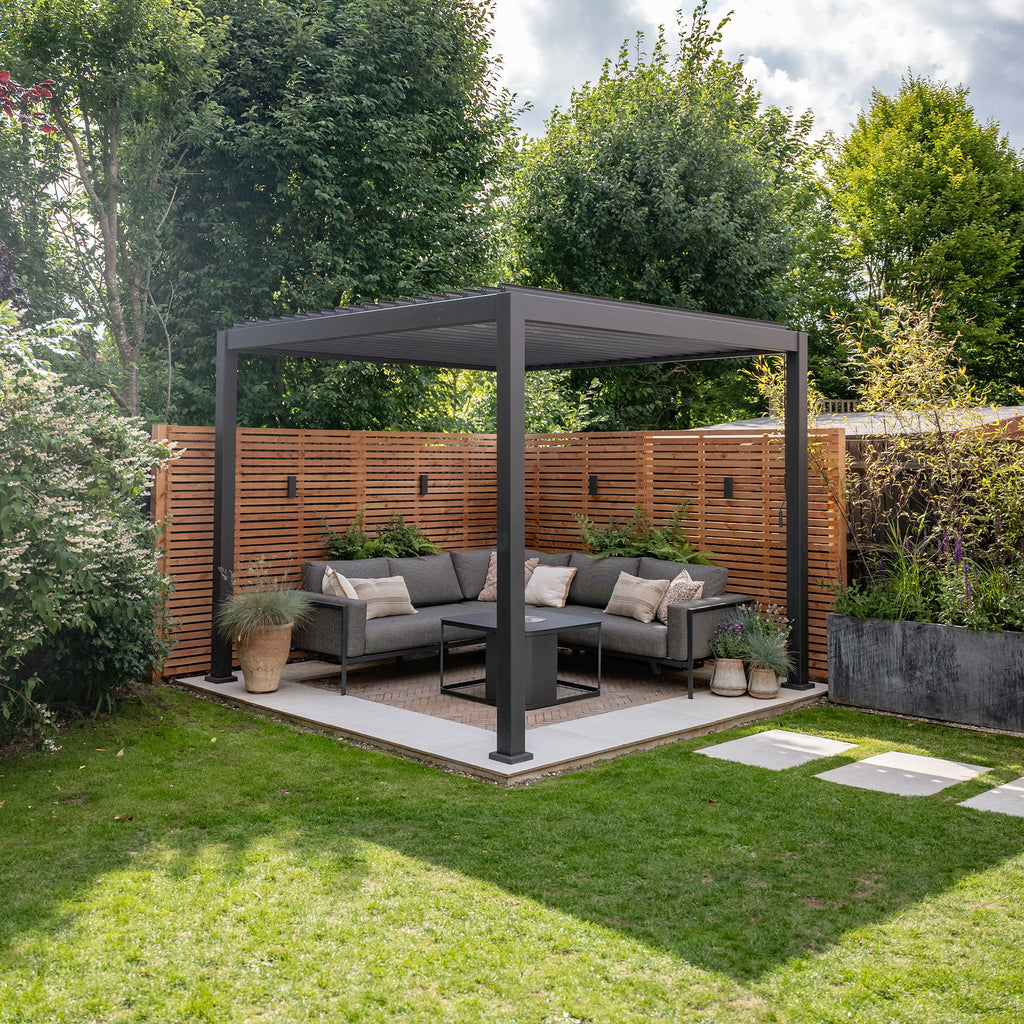 Lifestyle image of Larch Slatted Fence Panels installed in a garden setting 