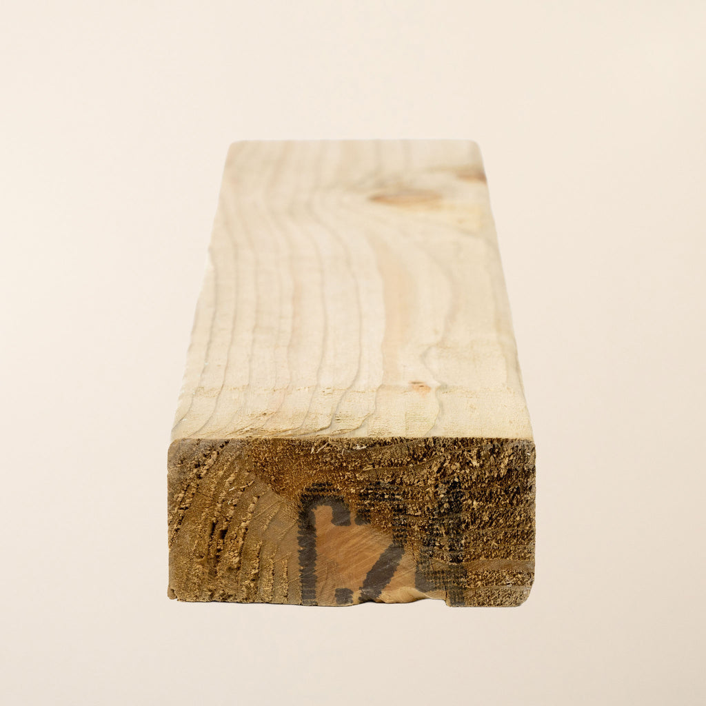 C24 4" x 2" Pressure Treated timber showing the planed finish and green tanalith treatment, measuring 95mm x 45mm and available in lengths from 2.4m to 4.8m 