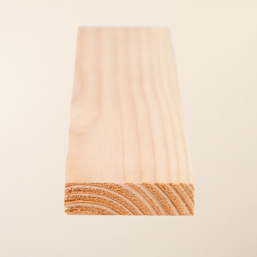 Close-up of planed British larch 3x1 board showing grain detail 