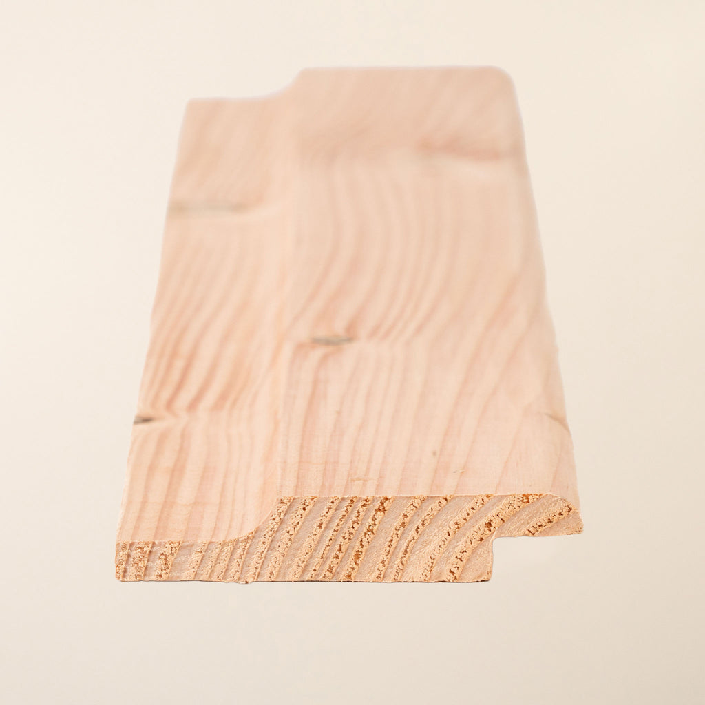 British Larch Shiplap cladding boards measuring 95mm x 19mm with 82mm face coverage, showing the planed finish and natural warm pinkish-brown tones of this untreated, naturally rot-resistant timber 