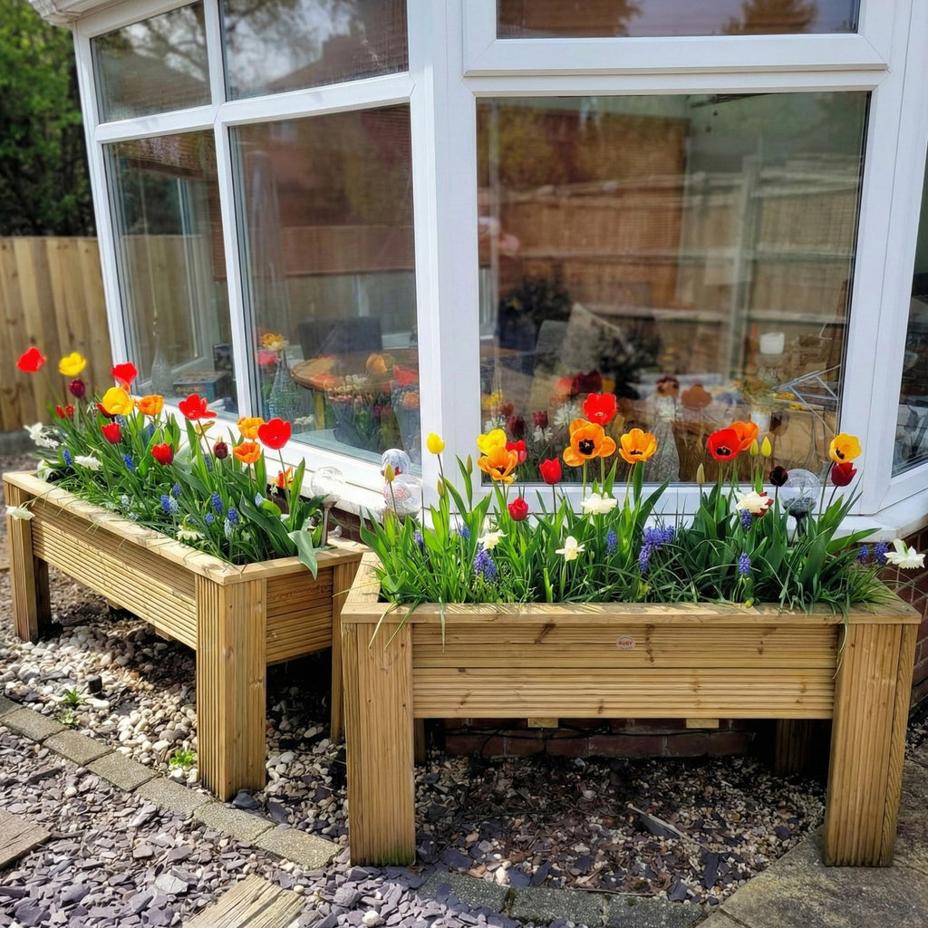 Premium timber decking raised planter in a garden with flowers 
