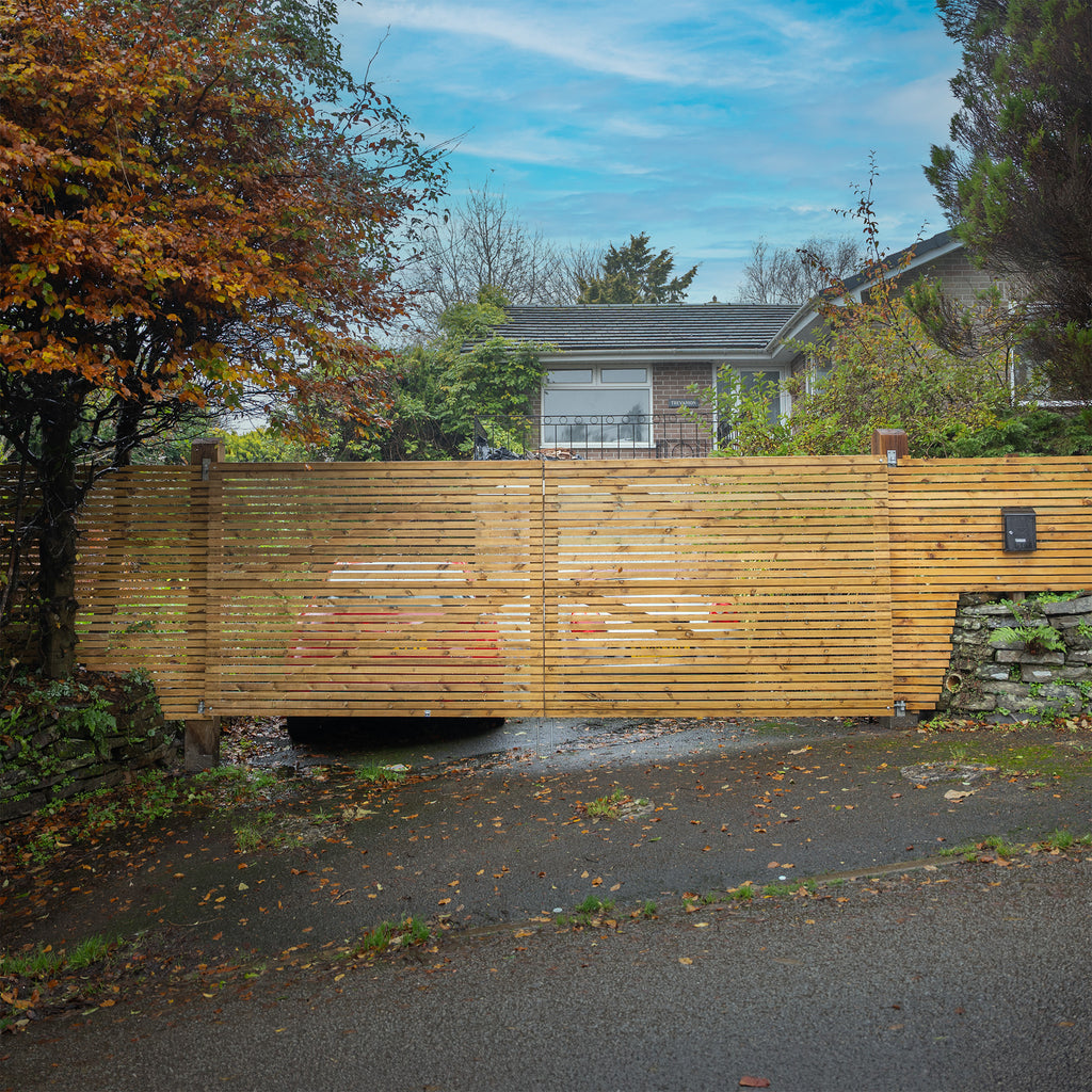 Lifestyle shot of Redwood Slatted Gates Pair, installed in a driveway 