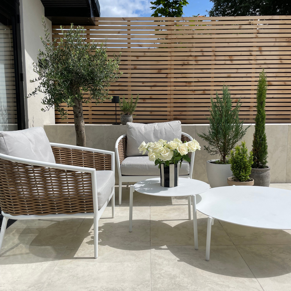 Cedar slatted fence panel with horizontal design shown in garden setting, displaying natural wood grain and even slat spacing 