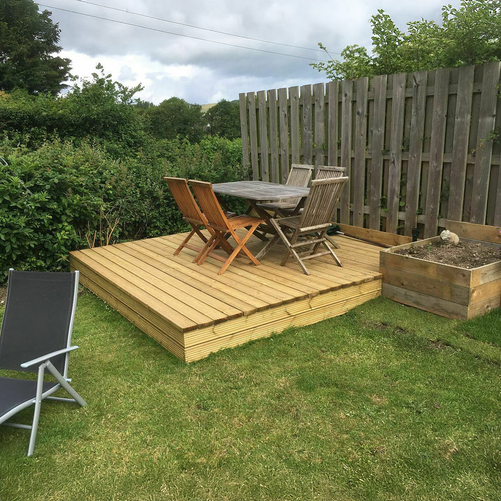 Cedar Decking installed in garden with garden furnature 