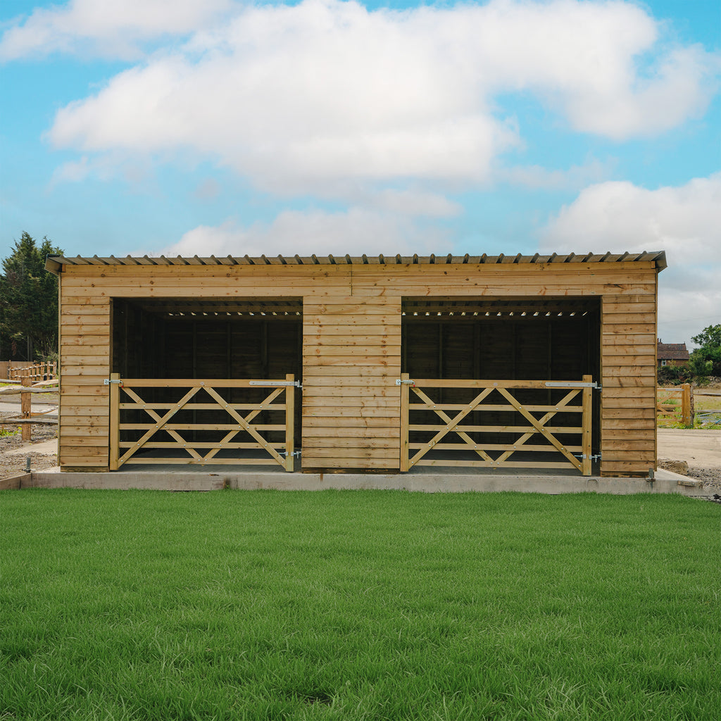 Field Shelter with 3.8m depth shown in rural setting, featuring pressure-treated timber construction with featheredge cladding and corrugated galvanized roof 